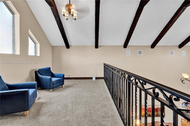 sitting room featuring beamed ceiling and carpet flooring