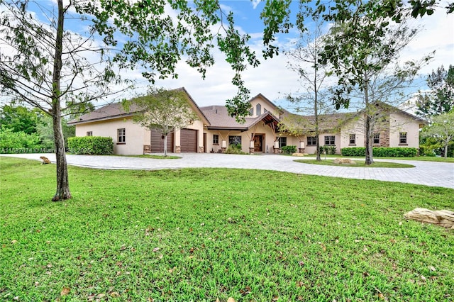 ranch-style house with a garage and a front lawn