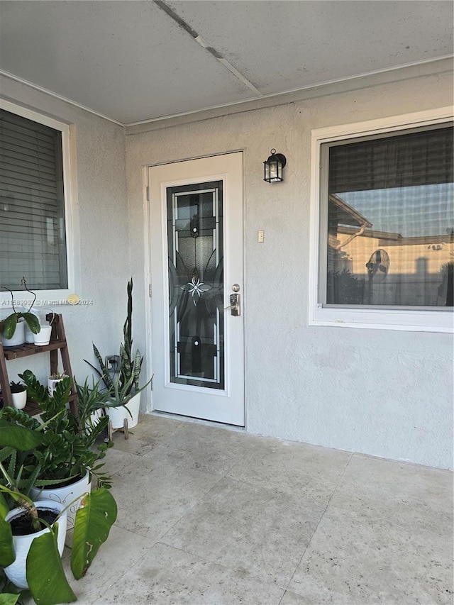 entrance to property featuring a patio area