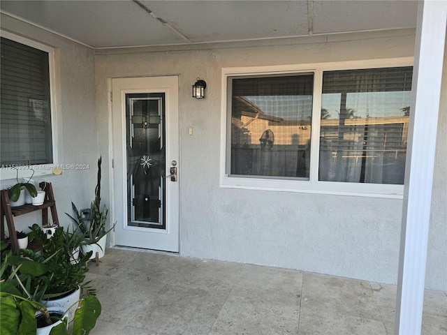 view of exterior entry featuring a patio