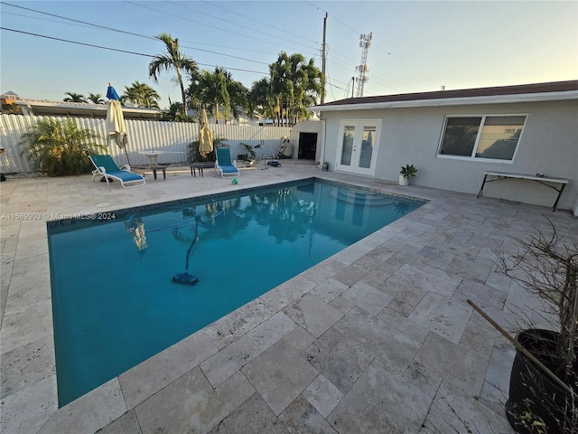 view of swimming pool with a patio area and french doors