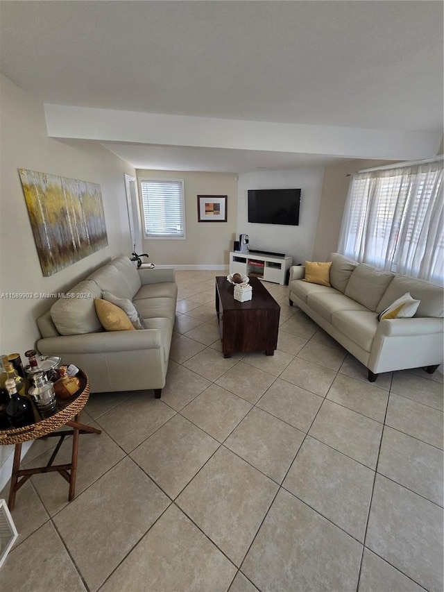 tiled living room with a healthy amount of sunlight