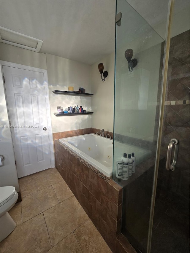 bathroom featuring tile floors, independent shower and bath, and toilet