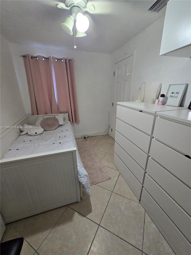 bedroom featuring ceiling fan and light tile floors