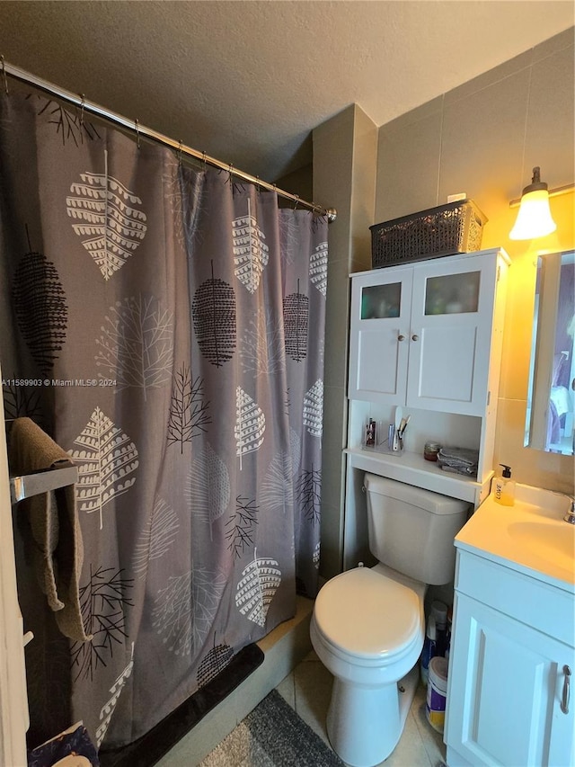 bathroom featuring tile floors, toilet, and vanity