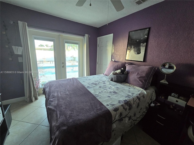 bedroom featuring ceiling fan, tile floors, and access to outside