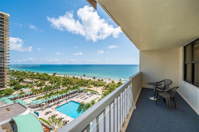 balcony featuring a view of the beach and a water view