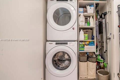 laundry area with laundry area and stacked washer and clothes dryer