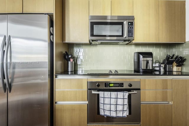 kitchen with light brown cabinets, backsplash, and appliances with stainless steel finishes