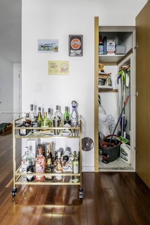 bar with hardwood / wood-style floors