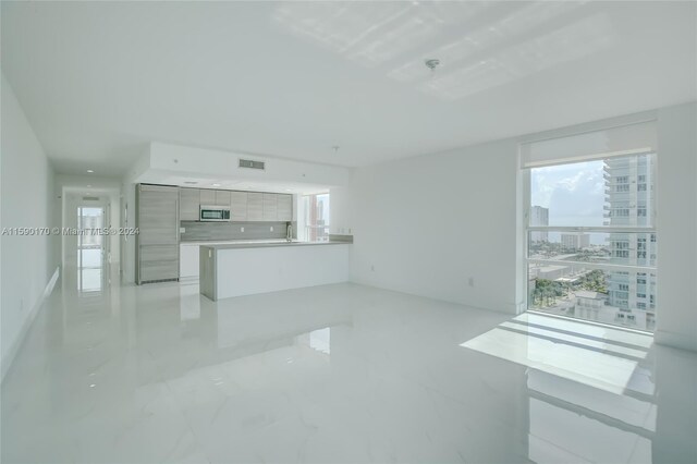 unfurnished living room featuring light tile patterned floors