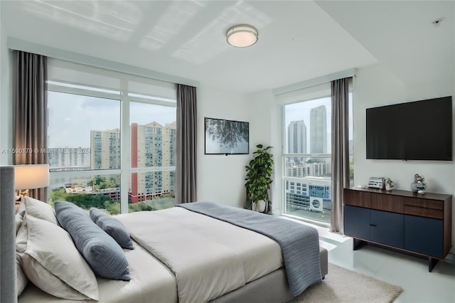 bedroom featuring light tile patterned flooring and multiple windows