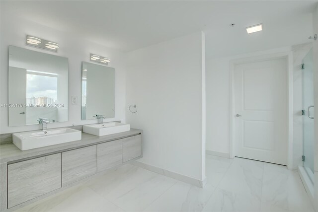 bathroom featuring dual vanity and tile patterned flooring