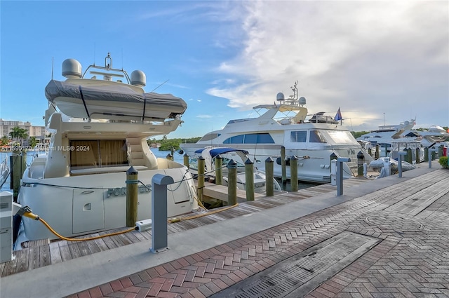 surrounding community with a water view and a boat dock