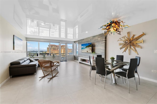 dining room featuring a towering ceiling and light tile floors