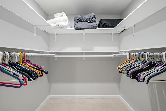 walk in closet with tile floors