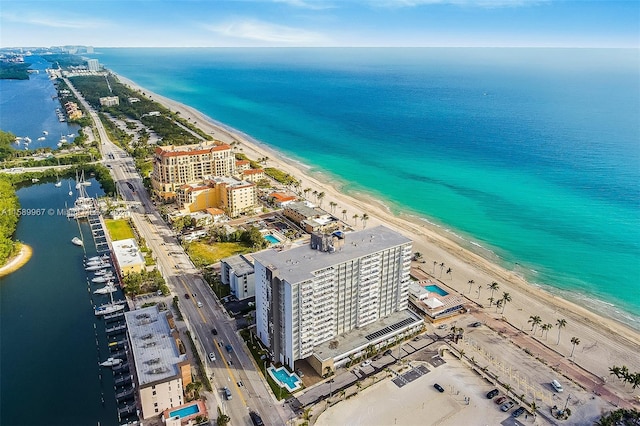 birds eye view of property featuring a view of the beach and a water view