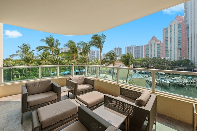 balcony with a water view and an outdoor hangout area