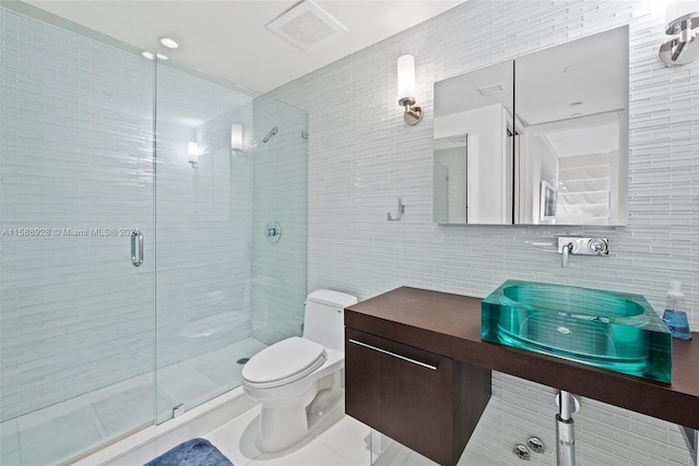 bathroom with tile walls, toilet, tile floors, an enclosed shower, and vanity