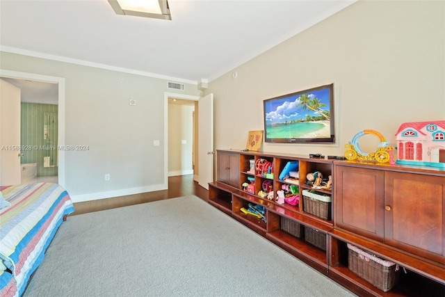 game room featuring crown molding and dark wood-type flooring