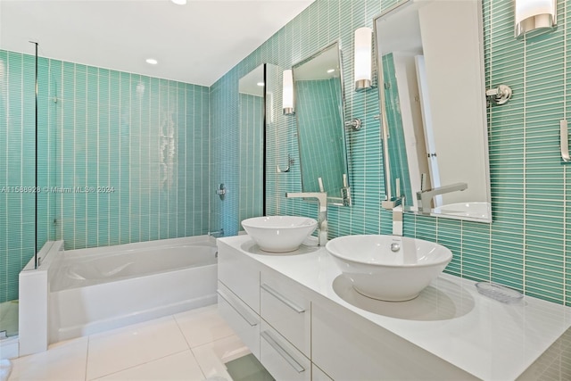 bathroom featuring tile flooring, double sink, tile walls, separate shower and tub, and oversized vanity