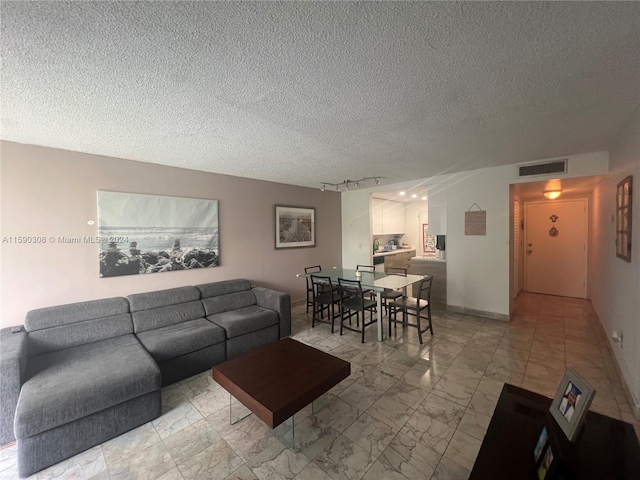 living room with a textured ceiling