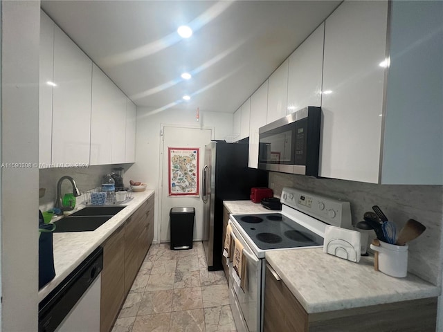 kitchen featuring white cabinetry, tasteful backsplash, sink, and white appliances