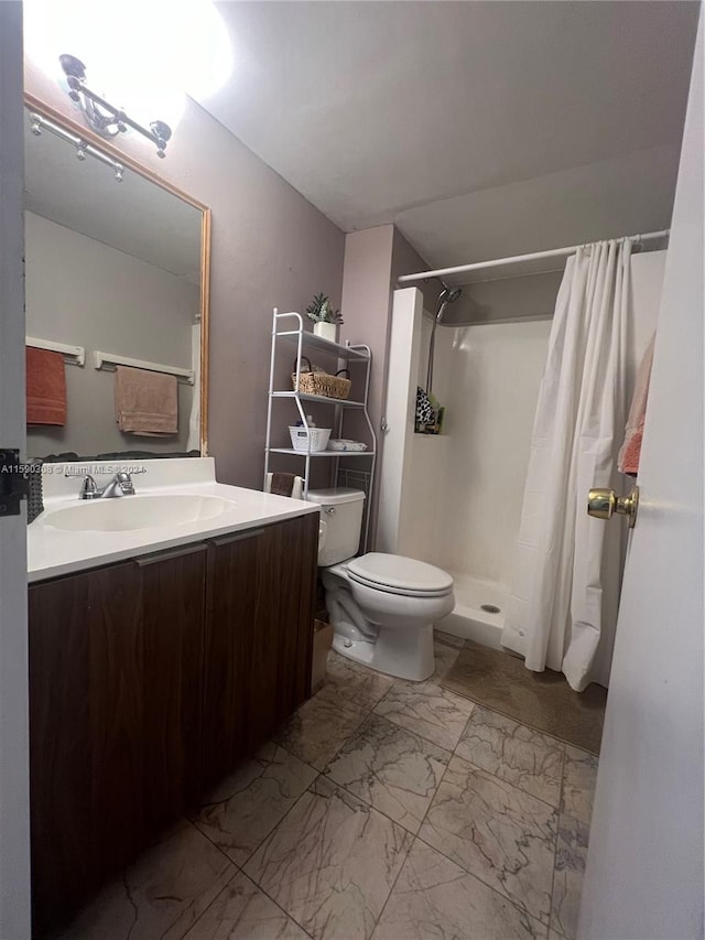 bathroom with vanity, a shower with shower curtain, and toilet