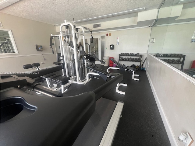 gym with a textured ceiling