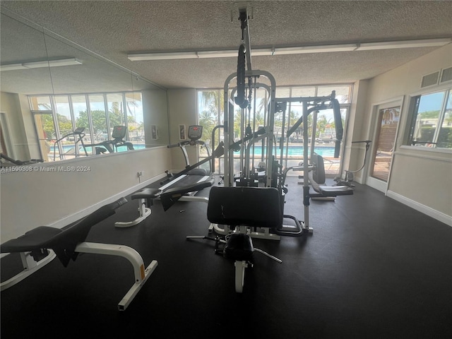 workout area featuring a wealth of natural light and a textured ceiling