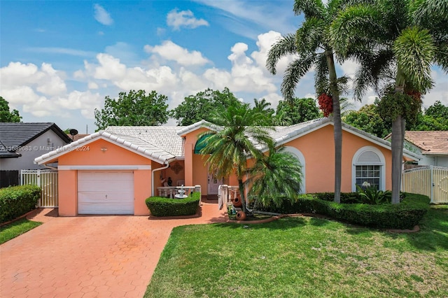 ranch-style home featuring a garage and a front yard