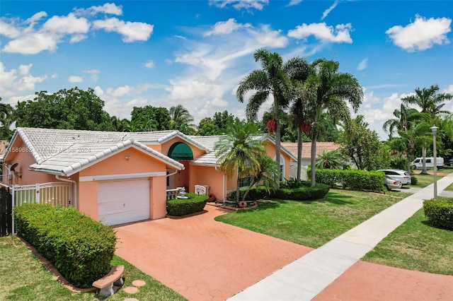 single story home featuring a front yard and a garage