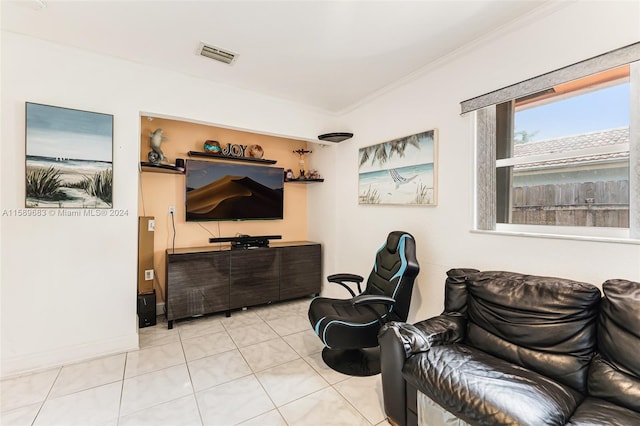 sitting room featuring crown molding and light tile flooring