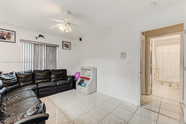 tiled living room featuring ceiling fan and crown molding