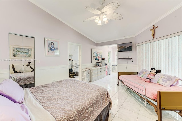 bedroom with vaulted ceiling, ceiling fan, light tile floors, and crown molding