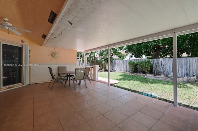 unfurnished sunroom with ceiling fan