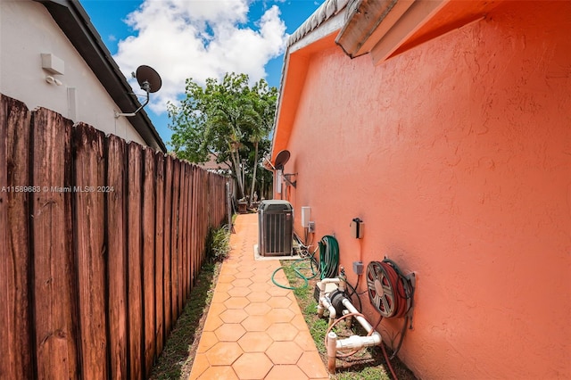 view of side of home featuring central AC unit