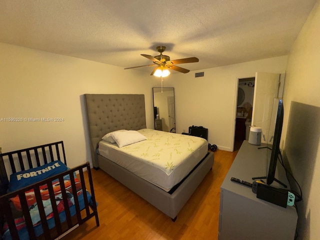 bedroom featuring ceiling fan, a textured ceiling, and hardwood / wood-style flooring