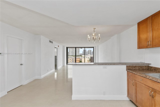 kitchen with kitchen peninsula and a chandelier