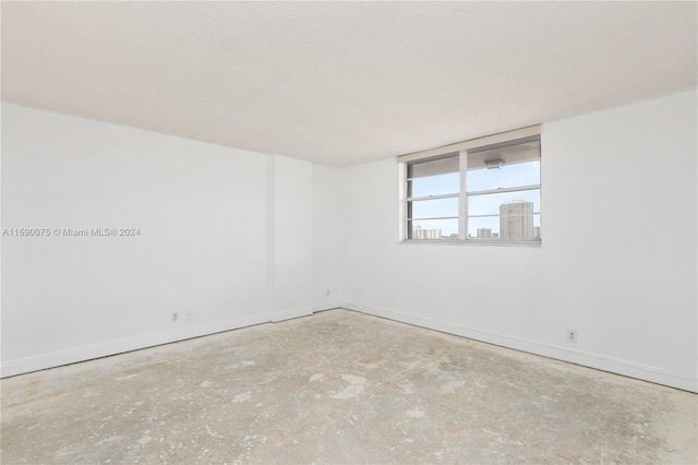 unfurnished room featuring a textured ceiling