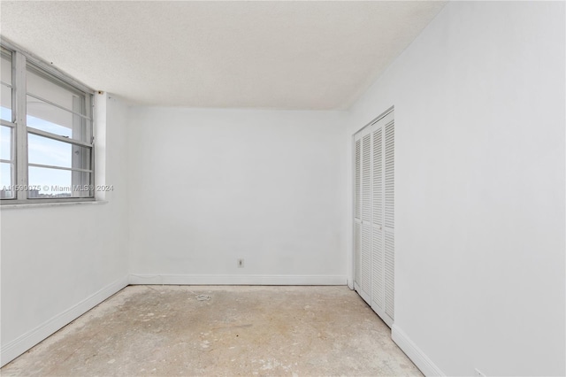 unfurnished bedroom with a textured ceiling