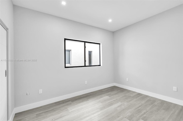 empty room with light hardwood / wood-style flooring