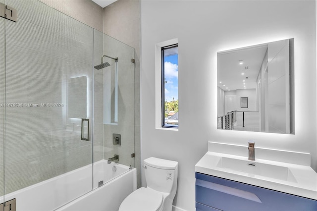 full bathroom with vanity, shower / bath combination with glass door, and toilet