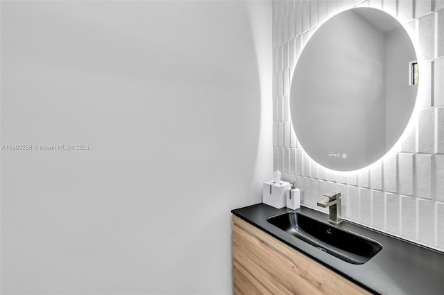 bathroom with vanity and tasteful backsplash