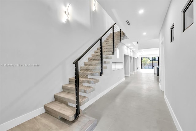 stairway with concrete flooring