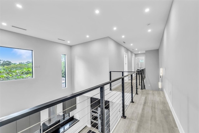 hallway with light hardwood / wood-style flooring