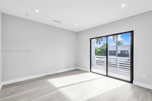 spare room featuring light wood-type flooring