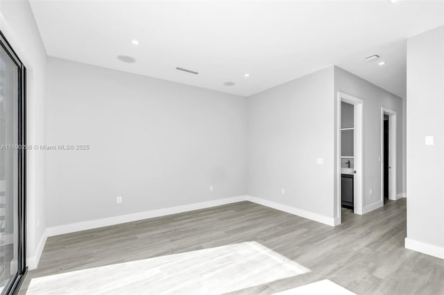 empty room with light hardwood / wood-style floors