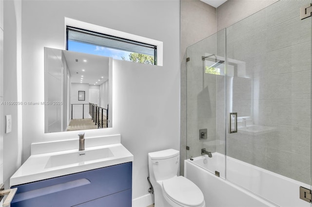 full bathroom with vanity, bath / shower combo with glass door, and toilet