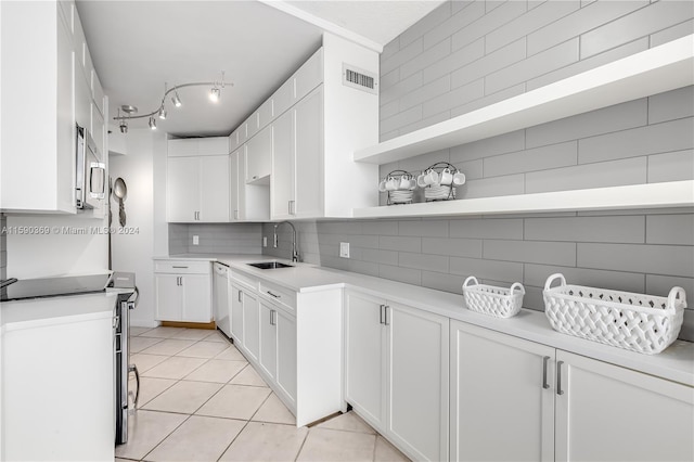 kitchen featuring sink, white cabinets, and stainless steel appliances